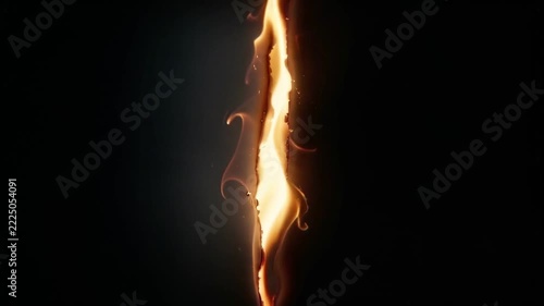Fire burning along a vertical slit in a dark background creating a glowing line of light.
