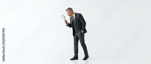 Businessman Inspecting with Magnifying Glass Focused on Detail White Background Professional Search