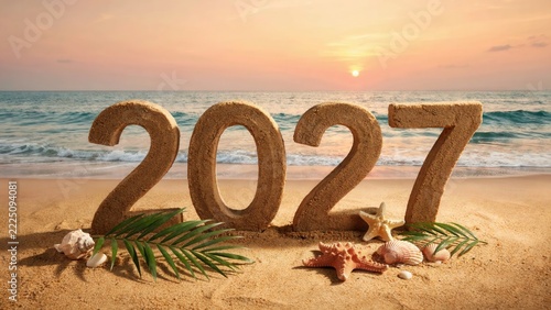 Year 2027 written in sand on a tropical beach at sunset