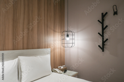 Modern minimalist  pendant lights with globe bulbs hanging against white wall.