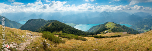 Panoramic view of lake Wolfgangsee with sunbeams and alpine hiking trail from Schafberg mountain in Salzkammergut Austria