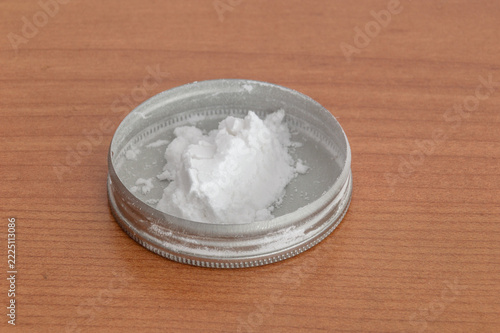 Close-up of a white powder in a metal cap.