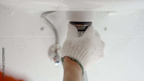 Repairing shink or washbasin drain.