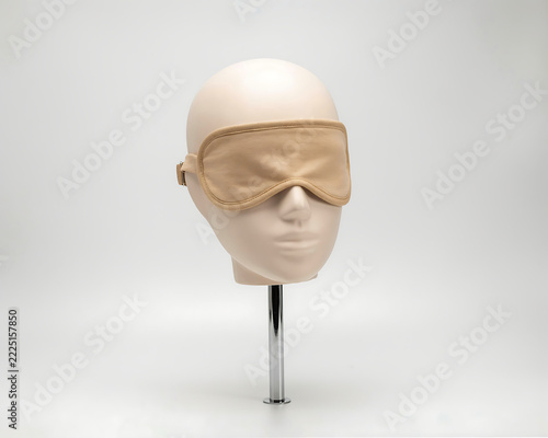 Mannequin head with beige sleep mask during studio shoot for rest and relaxation concept Isolated on transparent background