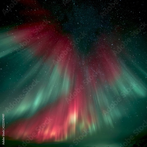 A stunning display of the aurora borealis lights up the night sky. Vibrant colors merge in a beautiful and dramatic scene. Perfect for backgrounds or nature themes. AI