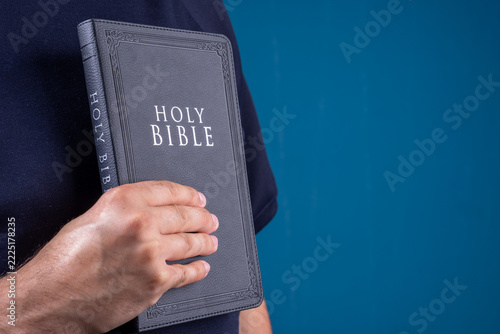 Obraz na plátně A person holds the Holy Scripture in their hands.