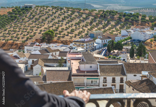 Senior tourist leaning on balcony looking at Andalusian village view