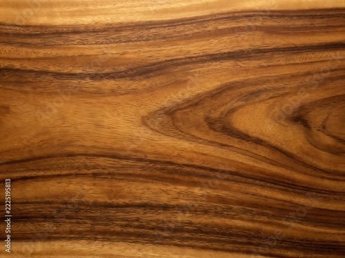Close up of rich koa wood grain texture with warm brown tones and natural patterns