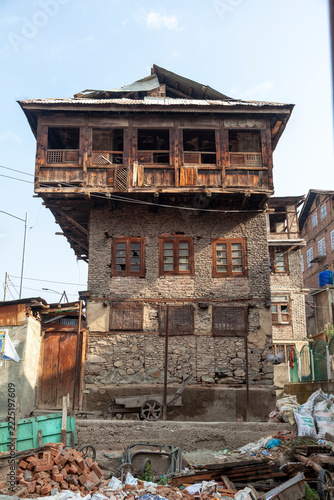 Old timber and stone house overhanging a demolition site, Jammu and Kashmir, Srinagar, India