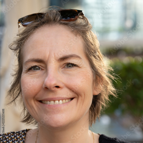 Smiling mature woman in her fifties with natural beauty and confidence