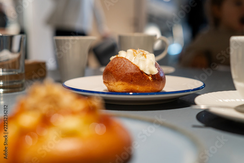 Sweet cream bun dessert on table with blurry background cafe