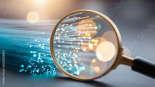 macro photograph of dense blue and cyan fiber optic cables transmitting data toward a magnifying glass highlighting a glowing semiconductor microchip pattern in blue and golden brown, intricate 