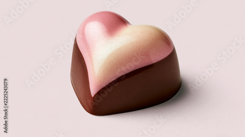 Pink and dark chocolate heart candy isolated on white background