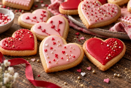 Heart Shaped Valentine Cookies with Pink Icing on a Rustic Table