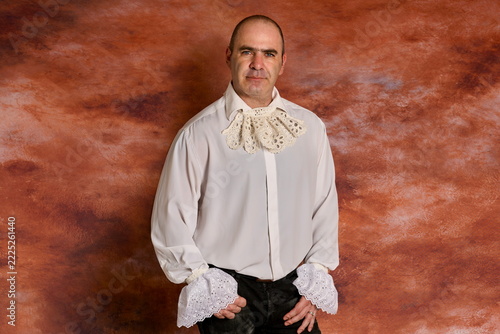 Elegant man posing in in 19th-century Victorian gown 
