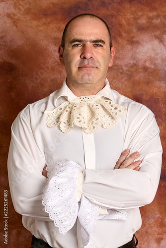 Elegant man posing in in 19th-century Victorian gown 