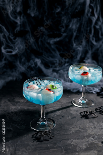 Halloween blue cocktails with spooky eyeballs and spiders