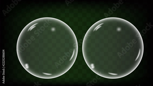 Two Transparent Soap Bubbles Floating on Green Background