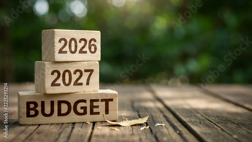 Wooden blocks stacked on rustic wooden table displaying future years and financial planning concepts clearly outdoors