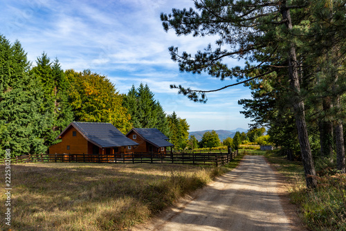 Countryside cottages in a mountain valley surrounded by lush forests in the Balkans