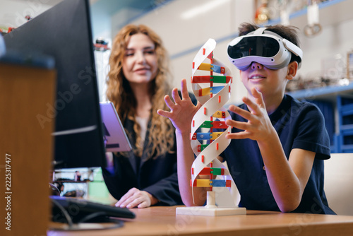 Boy wearing virtual reality headset exploring dna model classroom, AI intelligence technology for children in school