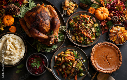 Thanksgiving dinner with roasted turkey pie mashed potatoes and roasted vegetables autumn decor.