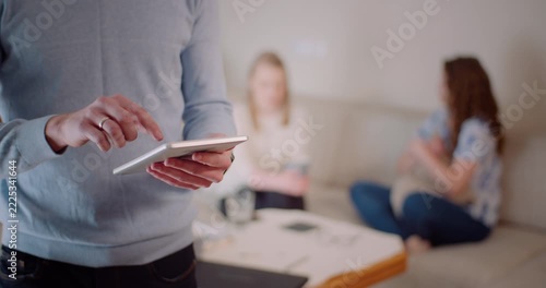 Two women having a calm conversation in a bright living room