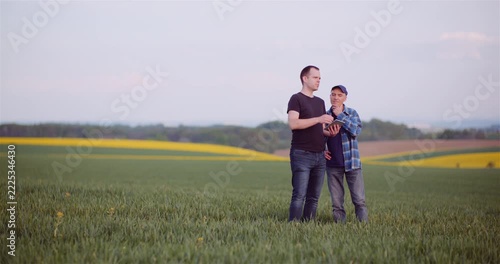 Two Men Talking in a Rural Countryside Field at Sunset