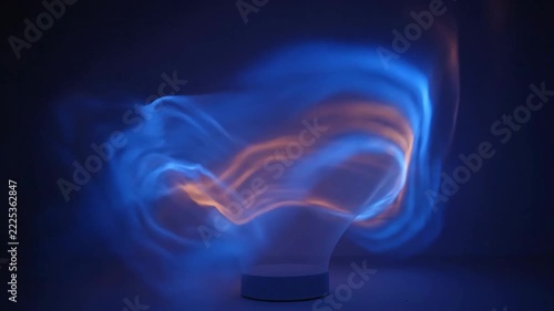 Mesmerizing blue and orange light patterns flow in an abstract, dark environment.