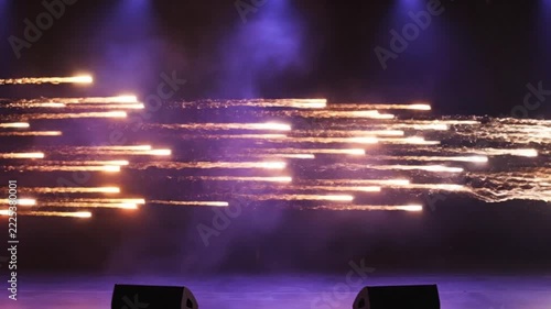 Stage pyrotechnics shooting horizontal sparks and explosive trails during live concert performance