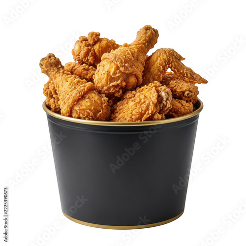 Crispy fried chicken pieces in a black bucket against black background