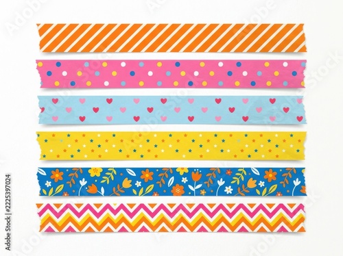 Colorful decorative tape strips with playful patterns on a white background during daylight