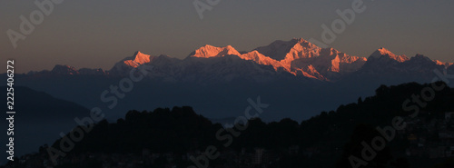 Bright lit peaks of Mount Kangchenjunga and other high mountains at sunrise, View from Darjeeling.