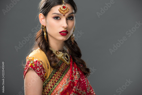 Young Indian woman celebrates Diwali in elegant saree and beautiful jewelry