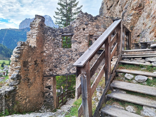 The ruins of the stone castle Wolkenstein in a mountain near the town of Selva val Gardena.