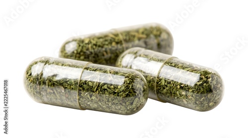 Herbal supplement capsules with green powder isolated on white