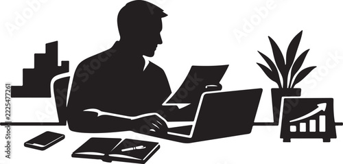 Businessman working on laptop with documents and office plant on desk.