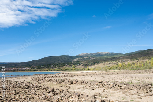 Reservoir with Low Water Level During Drought and Mountains