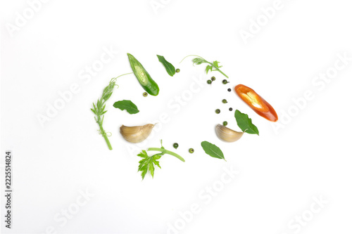 Culinary ingredients arranged in oval on white