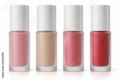 Four frosted cosmetic bottles with tall white caps in a colored lineup