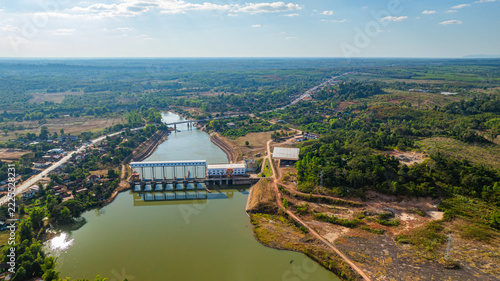 Fotografie aerial view of the Nam Hinboun River dam in Laos, showcasing hydropower infrastructure surrounded by lush green countryside