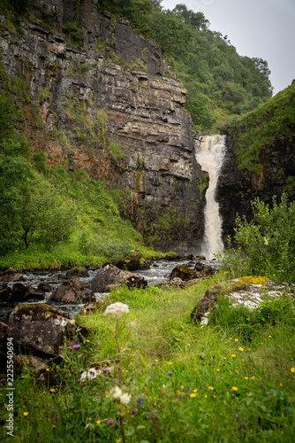 Waterfall in a lush Scottish mountain gorge