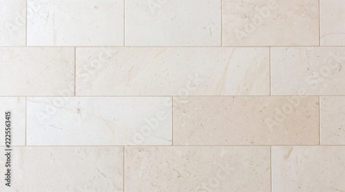 Modern beige stone wall texture, smooth limestone tiled facade cladding background, light natural marble tile surface for interior design backdrop