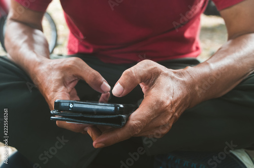 Close up of a man using and typing on smartphone with hands