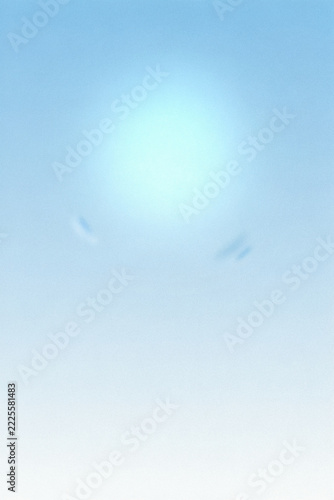 Soft gradient background, featuring a pale, blue sky with, a bright central, glow and faint, wispy clouds in, the distance
