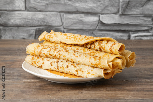 Stack of Fresh Crepes on a Rustic Plate