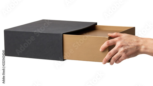 Hand pulling open a textured gift box revealing a golden interior during studio lighting