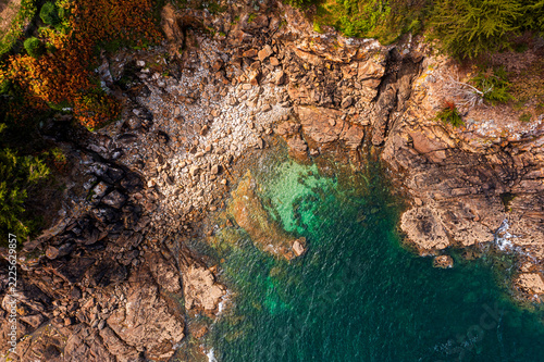 The beautiful French coastline along the Atlantic Ocean in Brittany, with rocks, azure water, and sand—a drone view.