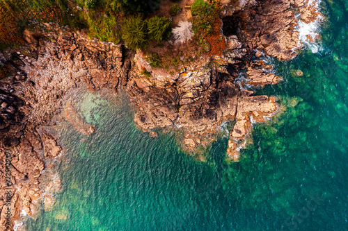 The beautiful French coastline along the Atlantic Ocean in Brittany, with rocks, azure water, and sand—a drone view.