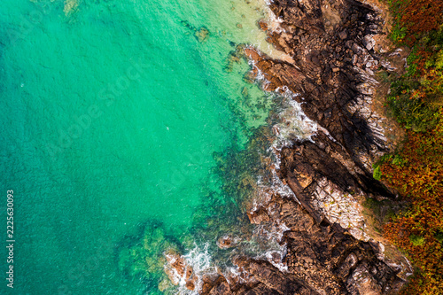 The beautiful French coastline along the Atlantic Ocean in Brittany, with rocks, azure water, and sand—a drone view.